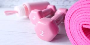 Menopause fitness with pink dumbells and yoga mat