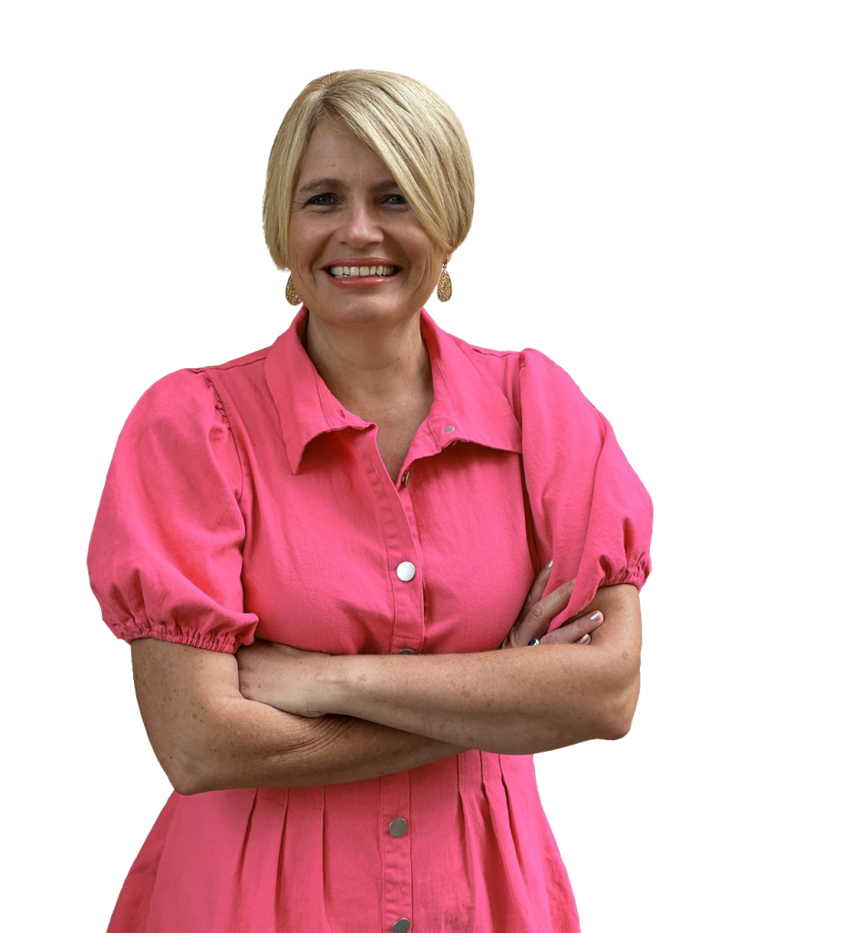 jenny vile wearing a pink dress, arms crossed