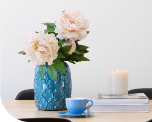 blue vase and flowers with candle